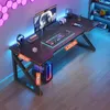 A gaming desk setup with a computer, monitor, keyboard, and headphones, illuminated by colorful LED lights. Podgląd zdjęcia produktu
