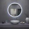 A modern bathroom vanity with a round LED mirror, a vessel sink, and decorative items. Náhled obrázku produktu
