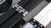 Close-up view of metal clips used to attach two different colored profiles. Produktbild-Vorschau