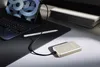 A desk setup with a tablet, stylus, and a power bank connected by a cable. Voir les images du produit