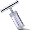 A silver-colored T-shaped pollen press is shown against a white background. Produktbild-Vorschau