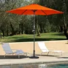 An outdoor patio scene with lounge chairs and an umbrella by a pool. Voir les images du produit