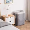 A laundry basket next to a nightstand in a bedroom. Produktbild-Vorschau