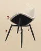 The underside of a chair is shown, with legs being attached. Produktbild-Vorschau