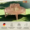 A wooden garden bench with a circular design around a tree trunk, placed on a lawn. Produktbild-Vorschau