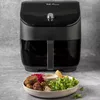 A black Instant Pot Vortex Plus Airfryer is shown in front of a grey background, with a plate of falafel and salad in the foreground. Produktbild-Vorschau