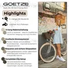 A woman is posing with a bicycle in front of a mosaic wall. Produktbild-Vorschau