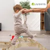 A child is being helped by an adult to climb on a wooden structure indoors. Náhled obrázku produktu