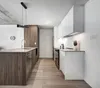 A modern kitchen with a wooden island and white cabinets. Produktbild-Vorschau