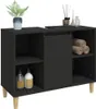 A black bathroom vanity cabinet with wooden legs, containing shelves, a door, and toiletries. Voir les images du produit