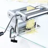 A chrome pasta maker with a handle is shown on a glass surface, producing fresh pasta. Podgląd zdjęcia produktu