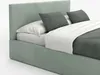 A mint green upholstered bed with two gray pillows and a white blanket. Produktbild-Vorschau