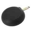 The underside of a black frying pan with a tan handle is shown against a white background. Podgląd zdjęcia produktu