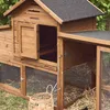 A wooden chicken coop with a run, situated outdoors on grass. Produktbild-Vorschau