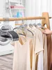 Clothes hangers are displayed on a rack in a laundry room setting. Produktbild-Vorschau
