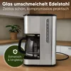A coffee maker is shown on a wooden countertop in a kitchen setting, with a plant in the background. Anteprima dell’immagine prodotto