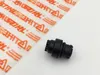 A black plastic part is placed next to a sheet of transparent plastic packaging with orange Stihl branding. Produktbild-Vorschau