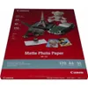 A package of Canon Matte Photo Paper with various small decorative items on top. Podgląd zdjęcia produktu