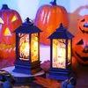 Two Halloween-themed LED lanterns are displayed in front of carved pumpkins and autumn leaves. Produktbild-Vorschau
