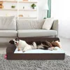 A dog is lying on a brown dog bed in a living room. Náhled obrázku produktu