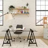 A modern home office setup with a glass-top desk supported by black trestle legs, a desk chair, and shelves on a white brick wall. Podgląd zdjęcia produktu
