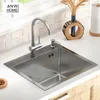 A stainless steel kitchen sink with a faucet and soap dispenser on a countertop. Produktbild-Vorschau