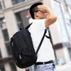A person wearing a backpack in an urban setting. Voir les images du produit