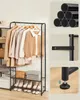 A metal garment rack with multiple shelves, displaying clothes, shoes, and accessories. Náhled obrázku produktu
