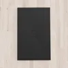 A black shower tray on a light wood floor. Produktbild-Vorschau