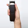 A hand holding a hair clipper. Podgląd zdjęcia produktu