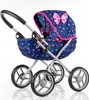 A doll's pram with a navy blue fabric and pink triangle pattern, and a pink bow on the hood. Produktbild-Vorschau