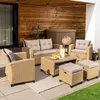 An outdoor patio setting with a polyrattan lounge furniture set. Produktbild-Vorschau
