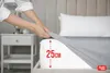 A person is putting a fitted sheet on a mattress, with a measurement indicator showing 25cm. Produktbild-Vorschau