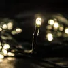 A close-up of a string of warm white LED lights against a dark background. Produktbild-Vorschau
