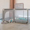 A grey playpen with balls inside, set up indoors. Anteprima dell’immagine prodotto