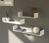 Three white U-shaped shelves mounted on a gray wall, displaying decorative items. Produktbild-Vorschau