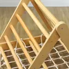 A close-up view of a wooden Montessori climbing structure with a net. Produktbild-Vorschau