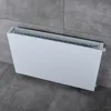 A white radiator is shown against a grey tiled wall and floor. Produktbild-Vorschau