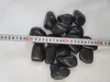 A pile of polished black pebbles with a measuring tape across them. Náhľad obrázku produktu