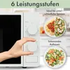 A hand is shown adjusting a dial on a white microwave oven. Two plates of food are displayed next to the microwave, one with spaghetti and salad, and another with mixed vegetables. Text overlays describe features. Produktbild-Vorschau