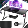 A gaming desk setup with a monitor, keyboard, mouse, headphones, and accessories, presented in a dynamic, promotional style. Produktbild-Vorschau