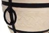 A close-up view of a textured beige pot with black straps and a metal ring. Anteprima dell’immagine prodotto