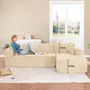 A woman is relaxing on a large, beige corduroy sectional sofa in a living room setting, with a window and a white cabinet in the background. Produktbild-Vorschau