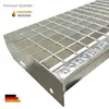 A close-up, angled view of a galvanized steel grating stair with a railing on the left side, set against a white background. The image also includes a logo and text indicating 'Premium Qualität' and 'Made in Germany'. Produktbild-Vorschau
