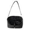 A black pet car seat with a fuzzy interior and a strap is shown hanging against a white background. Produktbild-Vorschau