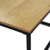 A close-up view of the corner of a wooden table with a black metal frame. Voir les images du produit