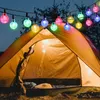 A tent at night with colorful string lights illuminating the scene. Produktbild-Vorschau