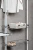 A close-up view of a modular wardrobe system with shelves and baskets, showcasing shoes and a storage basket. Produktbild-Vorschau