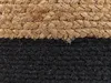 A close-up view of a woven pouf with two distinct color sections: a natural jute color and black. Náhled obrázku produktu