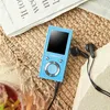 A blue MP3 player with black earbuds rests on a woven mat next to a newspaper and a drink. Produktbild-Vorschau